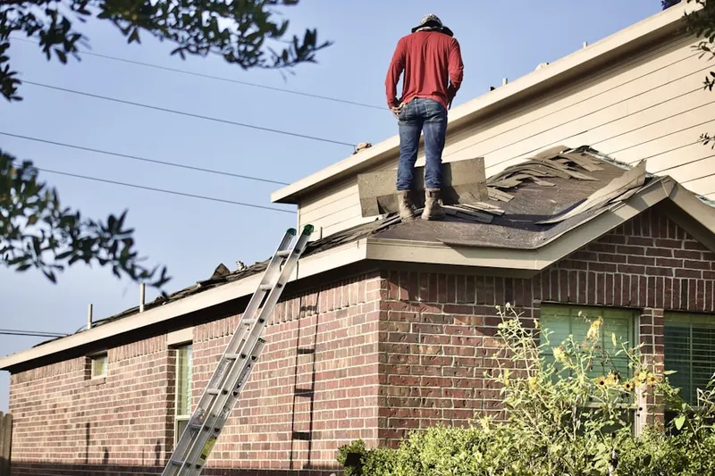 Professional roofer working on a residential roof in Erieville